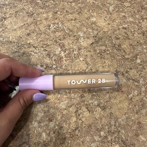 Tower 28 Cream and Purple Concealer Color: Pali tan with medium neutral